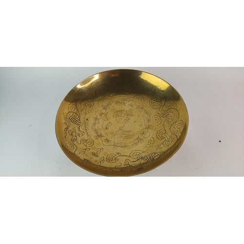 387 - A vintage brass and engraved bowl on a hardwood stand. Diameter measuring 36cm.