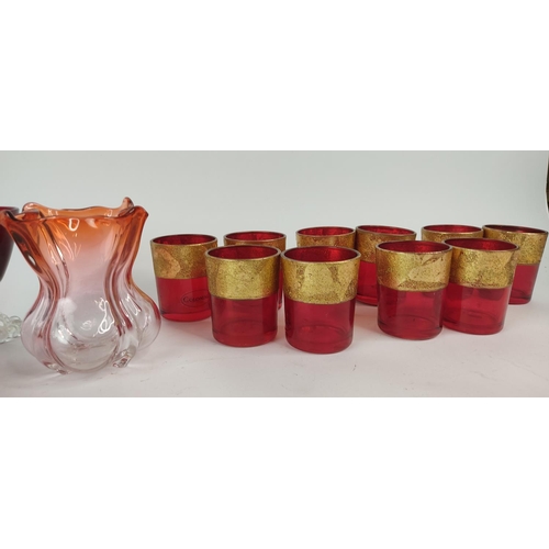 397 - A set of ten ruby and gilt glasses and other ruby glass.