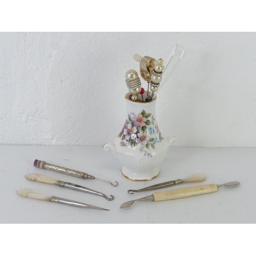 A collection of vintage button hooks, hat pins etc.