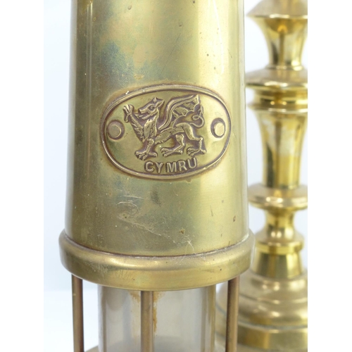 16 - A vintage brass miners lamp, pair of brass candlesticks &  anniversary clock.