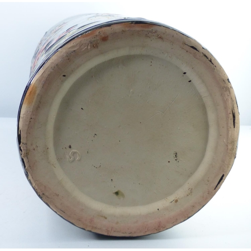 4 - A large decorative ceramic stick stand with floral design. 49cm tall