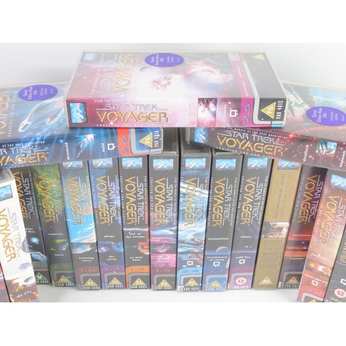 59 - A large collection of Star Trek Voyager video cassette tapes.