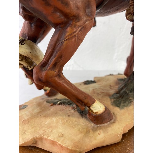 46 - A large resin figure of a cowboy on horseback, 45cm.