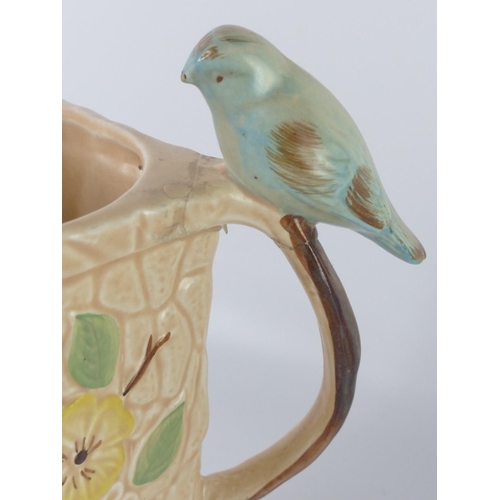 31 - A vintage Paramount Pottery jug with bird handle and another blue patterned jug (a/f).