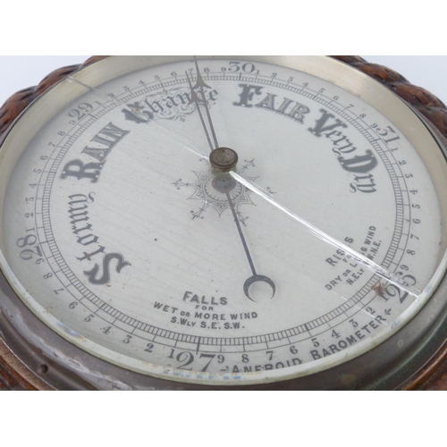 38 - A vintage oak cased aneriod barometer, with rope twist boarder (a/f), 28cm.