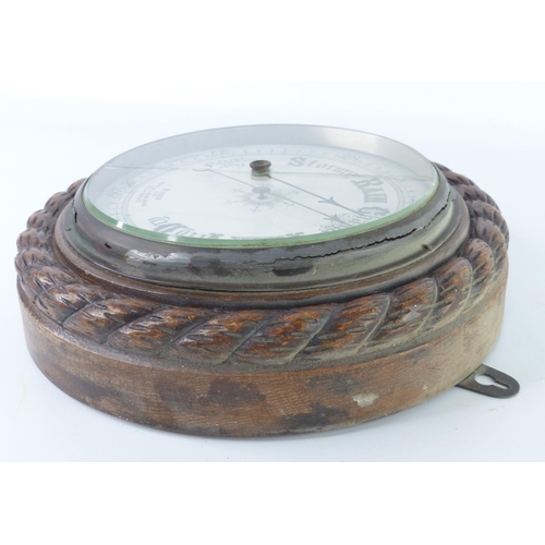 38 - A vintage oak cased aneriod barometer, with rope twist boarder (a/f), 28cm.