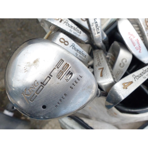8 - A golf bag, trolley and a collection of Powerbar by Vance clubs and more.