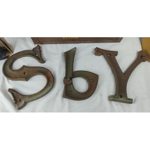 A vintage military box and cap, three cast metal letters 'SPY', and a ...
