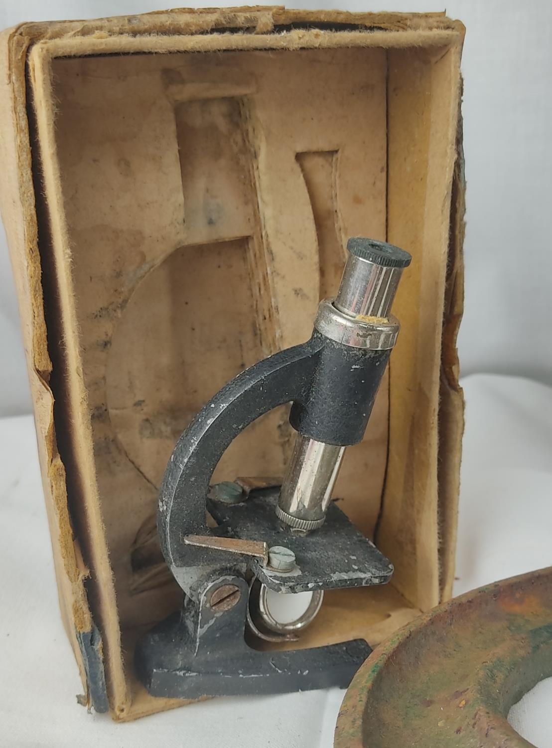 A vintage military box and cap, three cast metal letters 'SPY', and a ...