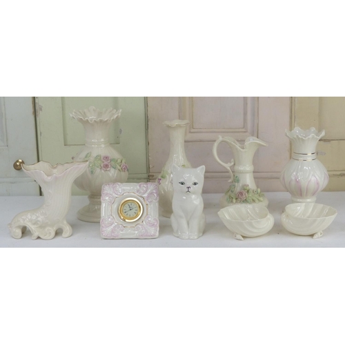 50 - A Belleek pottery flower encrusted vase and jug and more.