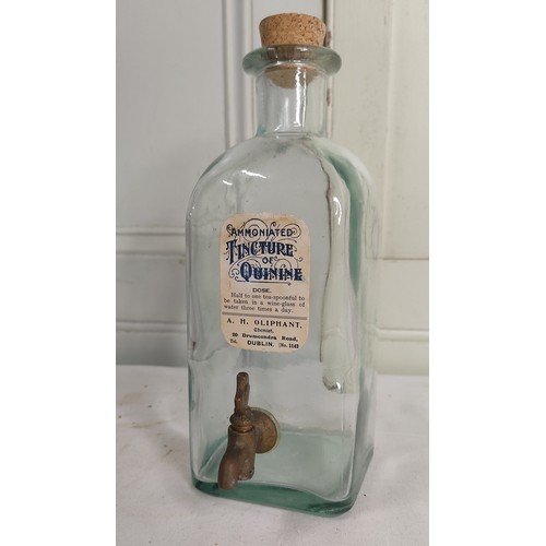 42 - An antique pharmacy bottle with original paper label for Ammoniated Tincture of Quinine.