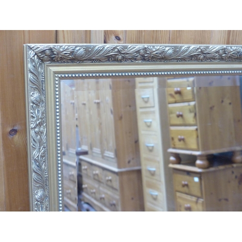 602 - A large gilt framed wall mirror, 89cm x 119cm.