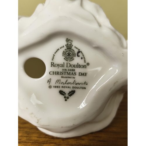 18 - A collection of 4 figures by Royal Doulton & Coalport, to include 'Christmas Day', 'Forget Me Not', ... 