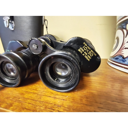 21 - A pair of cased Greencat binoculars.