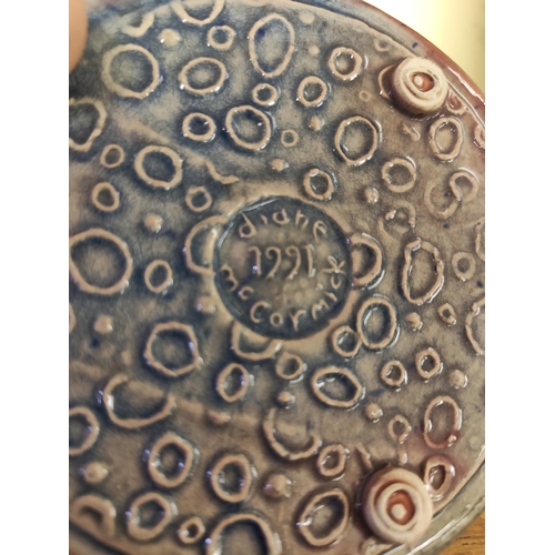 30 - A pair of studio pottery plaques, by Diane McCormick. Measuring approx 12cm in diameter