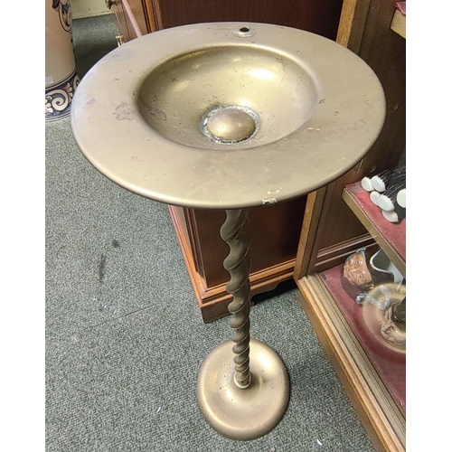 41 - A vintage floor standing brass ashtray with barley twist column. Measuring approx 57cm