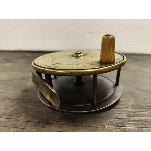 55 - A large antique brass fishing reel. Measuring approx 11cm