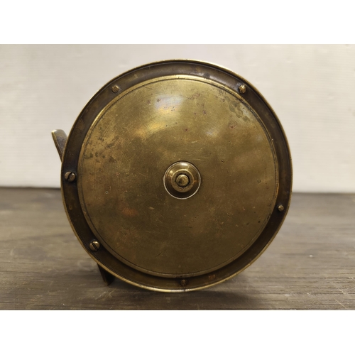 55 - A large antique brass fishing reel. Measuring approx 11cm