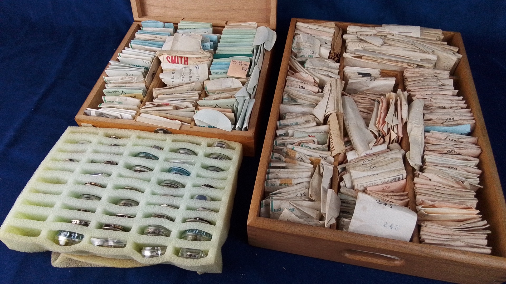 Group of assorted watchmakers’ parts, including numerous packeted ...