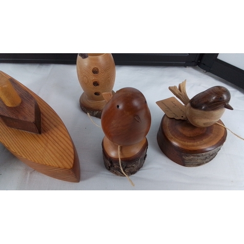 14 - Set of five hand-turned wooden ornaments comprising a toy racing car, toy boat, snowman figure, and ... 