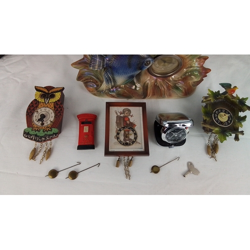 37 - Group of five assorted timepieces, comprising a figural fish mantel clock, three novelty cuckoo-styl... 