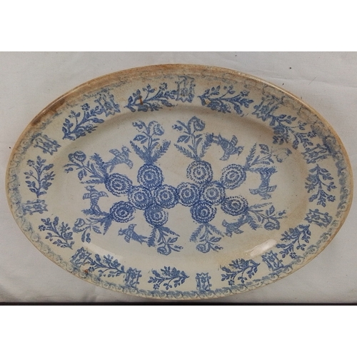 101 - An Irish spongeware platter, printed in blue with floral wreaths and foliate border, on a cream grou... 