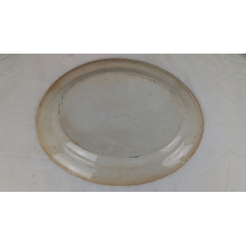 101 - An Irish spongeware platter, printed in blue with floral wreaths and foliate border, on a cream grou... 