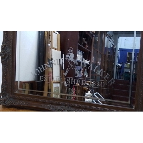 106 - A large rectangular wall mirror with bevelled plate and etched Johnnie Walker advertising motif, wit... 
