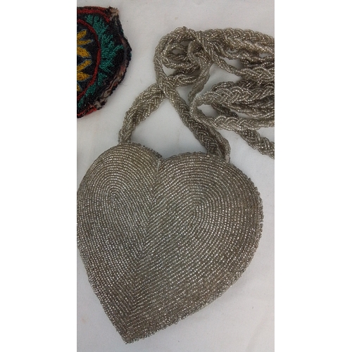 132 - Set of three vintage beaded accessories comprising a silver-tone heart-shaped evening bag with braid... 