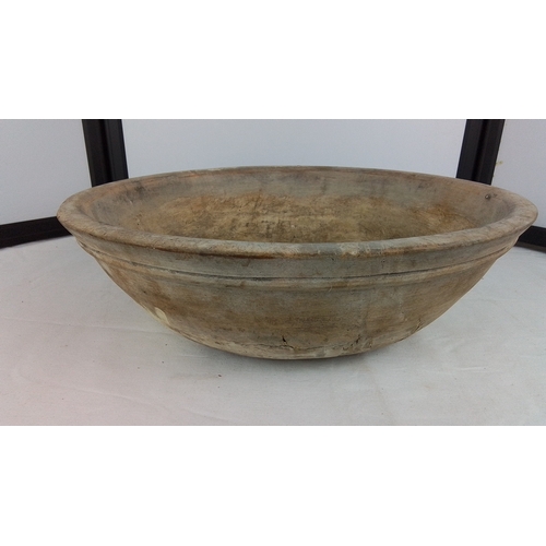 146 - An Irish hand-carved wooden dough bowl or trough, of elliptical form with thick rim and deep interio... 