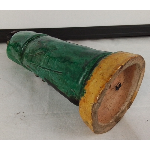 172 - A Chinese salt glazed pottery figure of a scholar in green robes, modelled standing with hand to bea... 