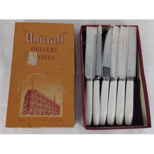 213 - Set of 6 Sheffield stainless steel dessert knives, each with white plastic handles and metal collars... 