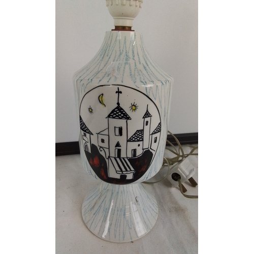 223 - A vintage ceramic table lamp base, of baluster form with flared foot, decorated with stylised villag... 