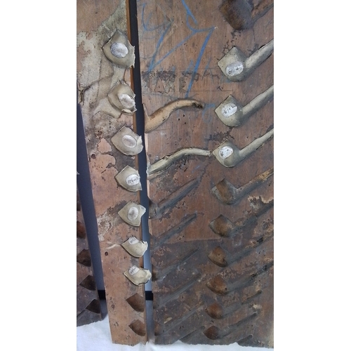 226 - Group of three wooden pipe-moulding forms, each fitted with multiple carved cavities and attached cl... 