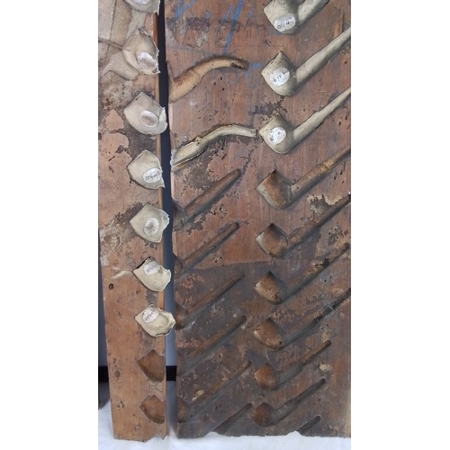 226 - Group of three wooden pipe-moulding forms, each fitted with multiple carved cavities and attached cl... 