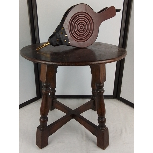 268 - A leather and ebonised wood fireplace bellows with brass nozzle and a vintage circular topped table.
