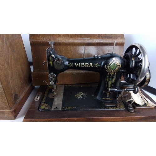 303 - A Vibra hand-cranked sewing machine, black japanned metal with gilt and polychrome floral decoration... 