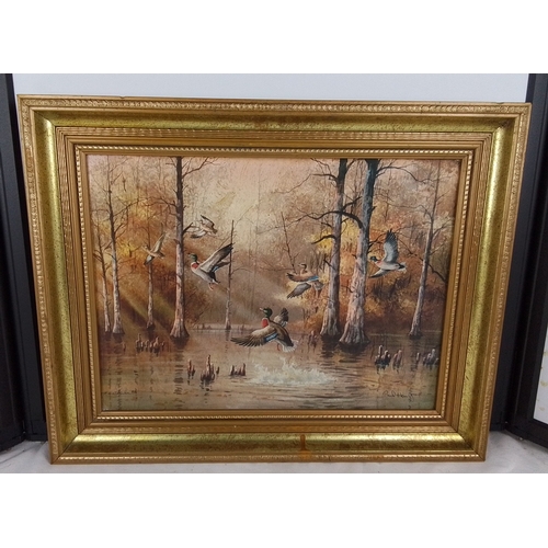 320 - A framed print depicting mallards in flight over a wooded marsh landscape, signed lower right “Paul ... 