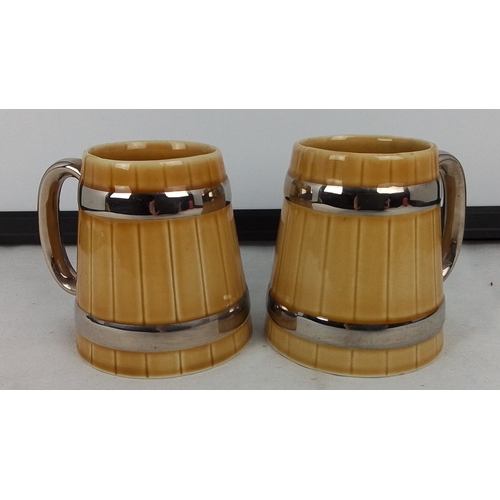 377 - Pair of Wade ceramic tankards, of barrel form with yellow glaze and chromed bands and handles, each ... 