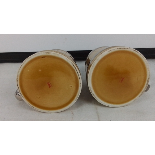 377 - Pair of Wade ceramic tankards, of barrel form with yellow glaze and chromed bands and handles, each ... 