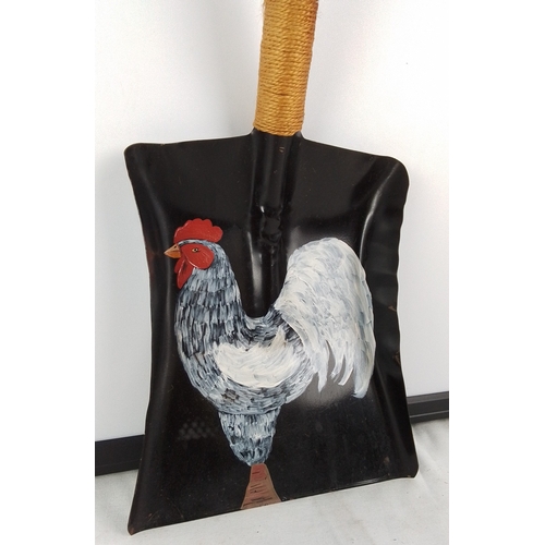 388 - A hand painted metal coal shovel with turned wooden handle and rope grip, the blade hand-painted wit... 