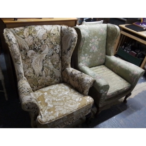 405 - Pair of upholstered wingback armchairs, one in green floral fabric with scroll arms, the other in ta... 