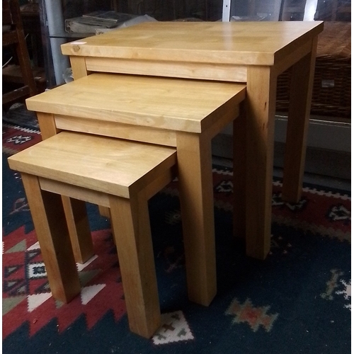 425 - Set of three graduated pine nesting tables, each rectangular with square-section legs, plain apron r... 