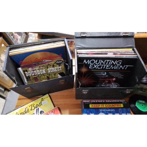 433 - Collection of vinyl records, including LPs and 45rpm singles, housed in three carry cases; visible t... 