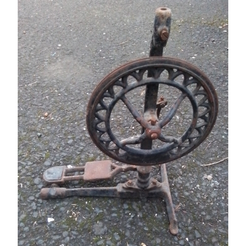 454 - A cast-iron treadle-operated grindstone frame, with spoked flywheel, foot pedal and tri-form base, f... 