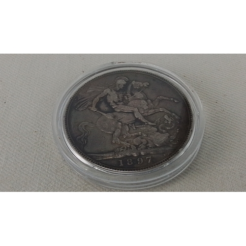 248 - A Victorian crown coin, dated 1897, with veiled head portrait of Queen Victoria and St George and th... 