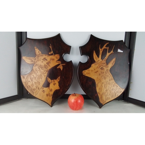 281 - Pair of shield-shaped timber wall plaques, each inlaid and engraved with deer studies, one showing a... 