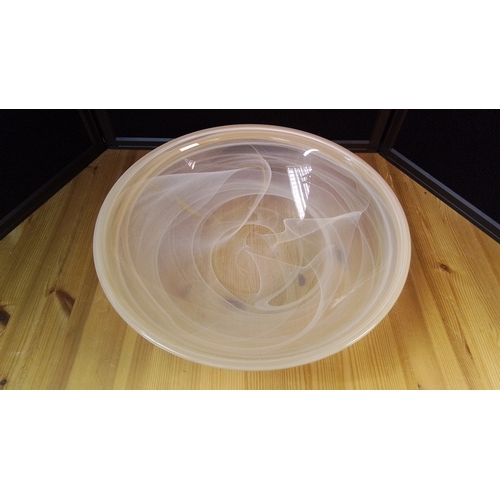 566 - A large contemporary art glass centre bowl of shallow circular form, the clear body with opaque whit... 