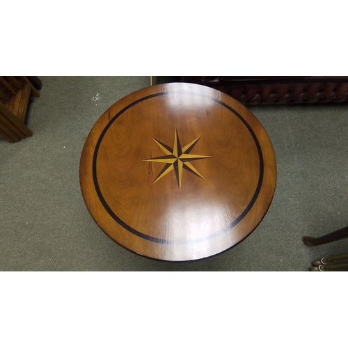 572 - A circular pedestal occasional table, the top inlaid with a compass-rose star and ebonised line bord... 