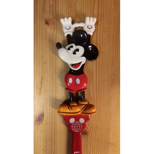 584 - A Walt Disney World Mickey Mouse plastic back-scratcher, modelled in relief with Mickey standing abo... 